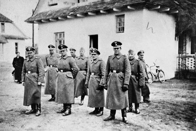 Bild: Lorenz Hackenholt (3. v. r.)  mit anderen Angehörigen des Lagerpersonals vor dem Kommandantenhaus des Vernichtungslagers Bełżec, 1942 
